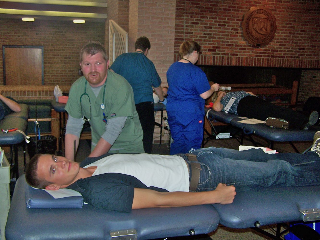 Donor Care Specialist Donald Marsh preps senior Josiah Ringelberg for donating blood. Photo by Connor Sterchi