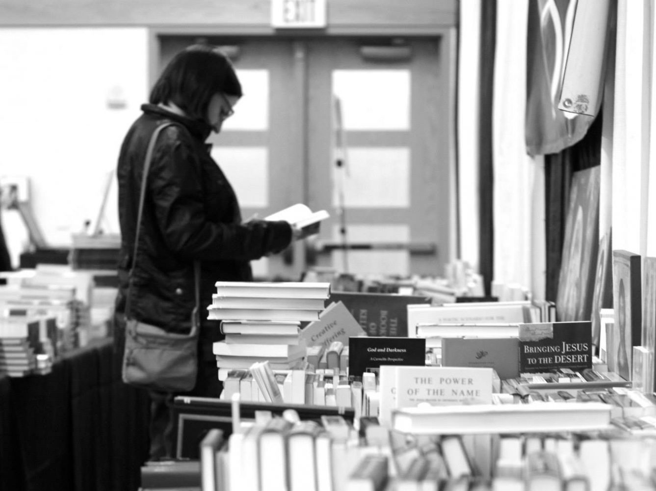 A participant browsing the books at the Festival of Faith and Writing in 2014, Photo courtesy Festival of Faith and Writing