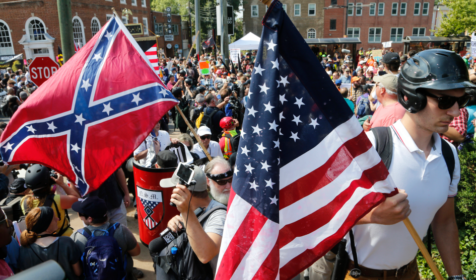Protesters in Charlottesville, VA wave confederate flags. Photo courtesy wkrn.com.
