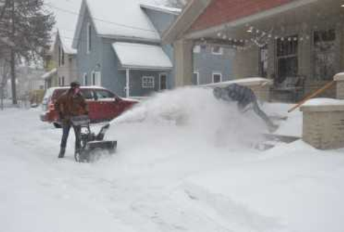 Clearing snow - Travis St. Project Neighborhood house. 
