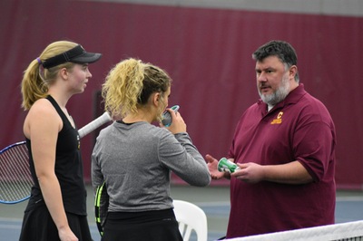 Coach Morey instructing two players