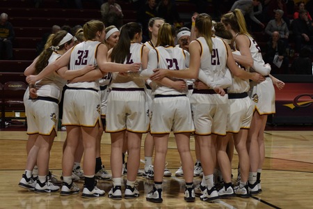 The womens team embracing each other during a game