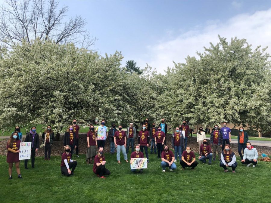 SAGA members hold up posters affirming the LGTBQ+ Christian community.