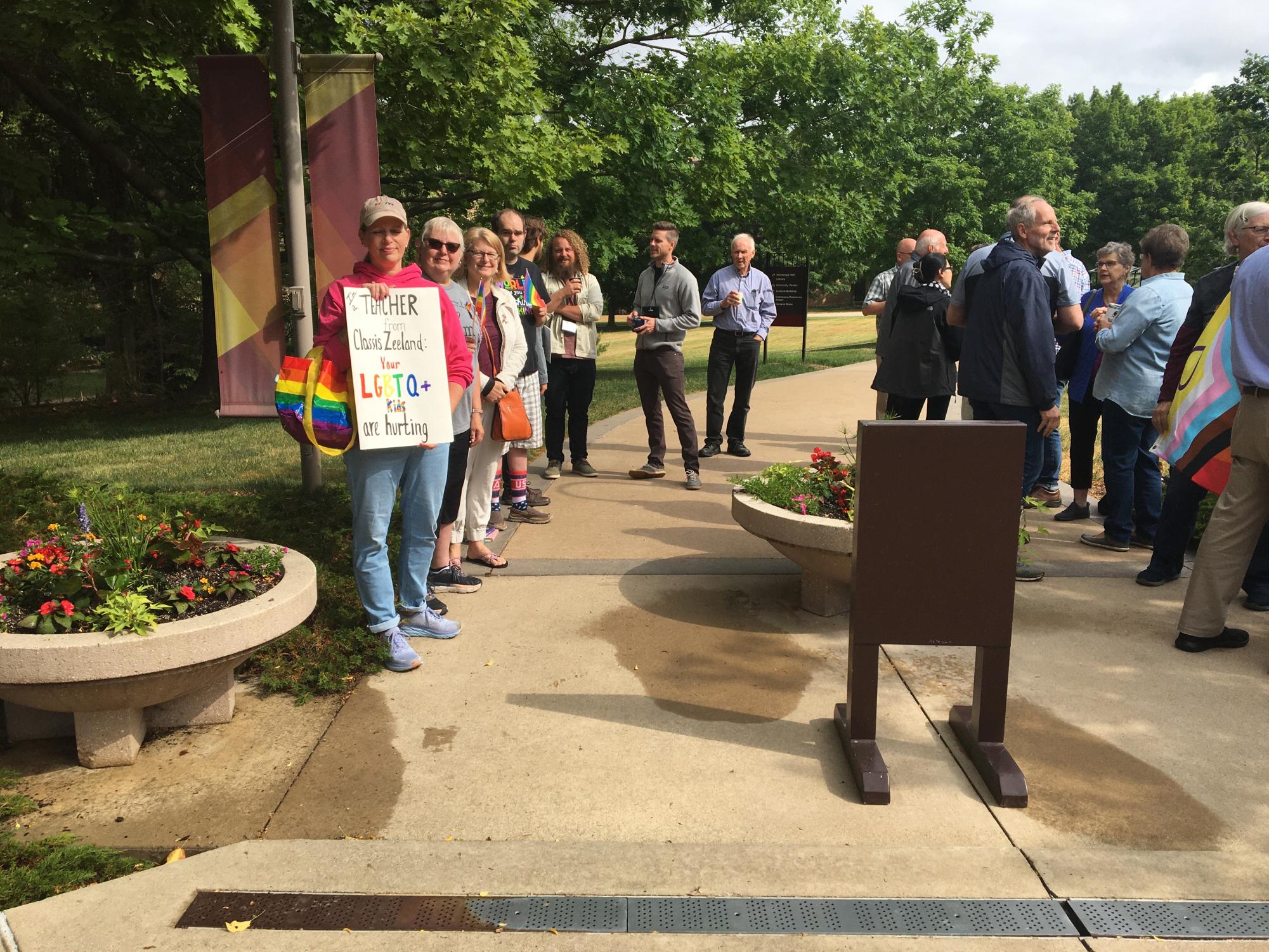 Protesters gather outside Calvin Universitys chapel, where Synod 2023 met from June 9 to 15. 