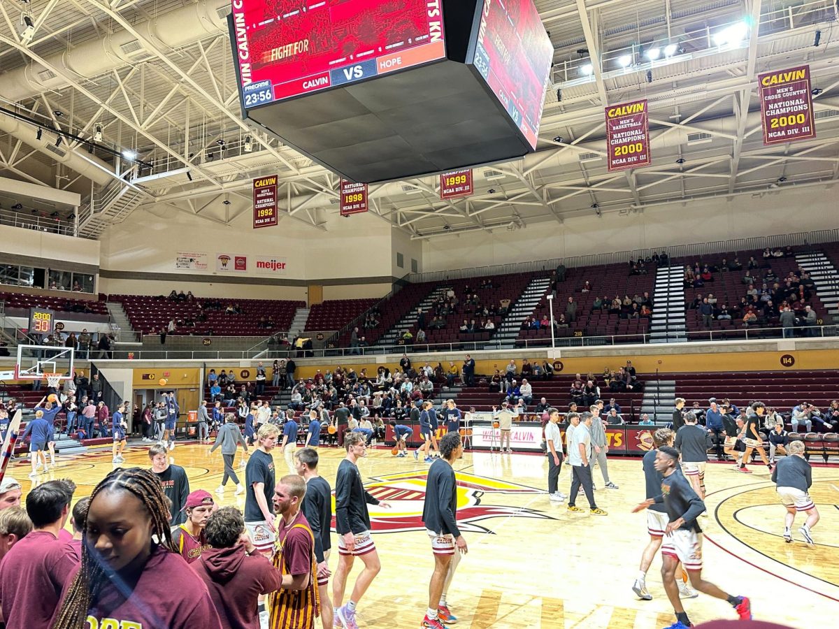 The basketball team warms up before a Calvin/Hope rivalry game.