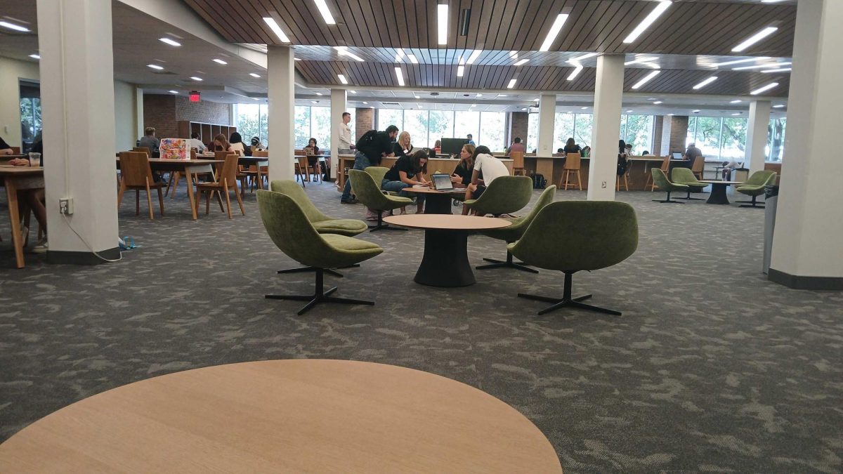 Students gather around a table on the second floor of the newly renovated Hekman Library.