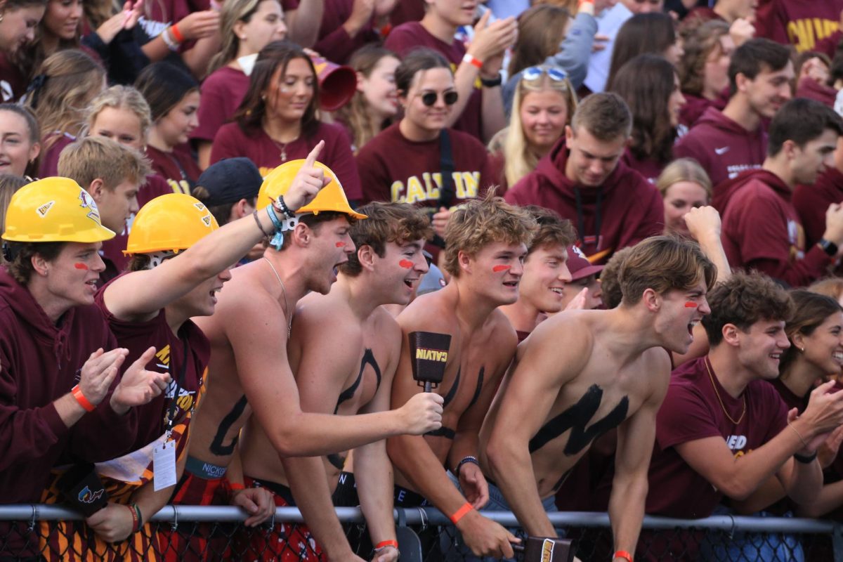 Spectators cheer on Calvin's football team at their first official game.