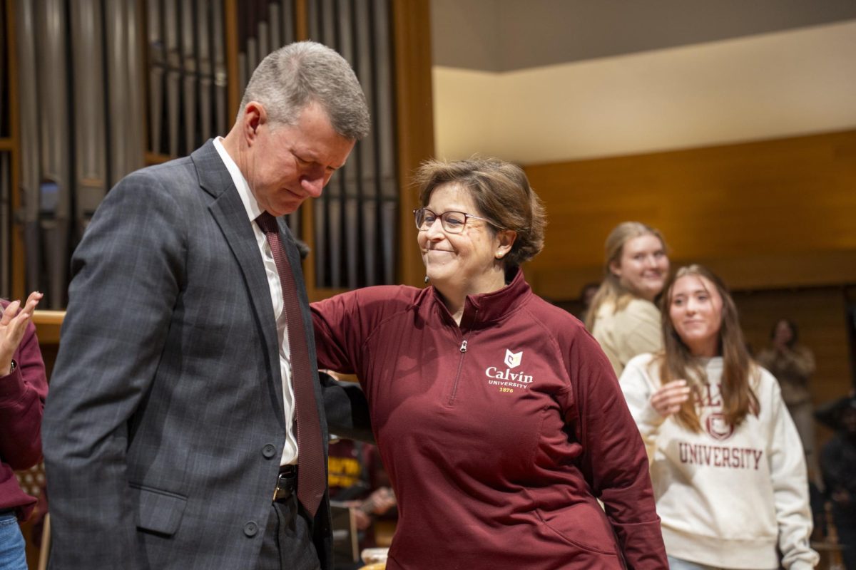 University pastor Mary Hulst prays for President Elzinga at a chapel service before his inauguration