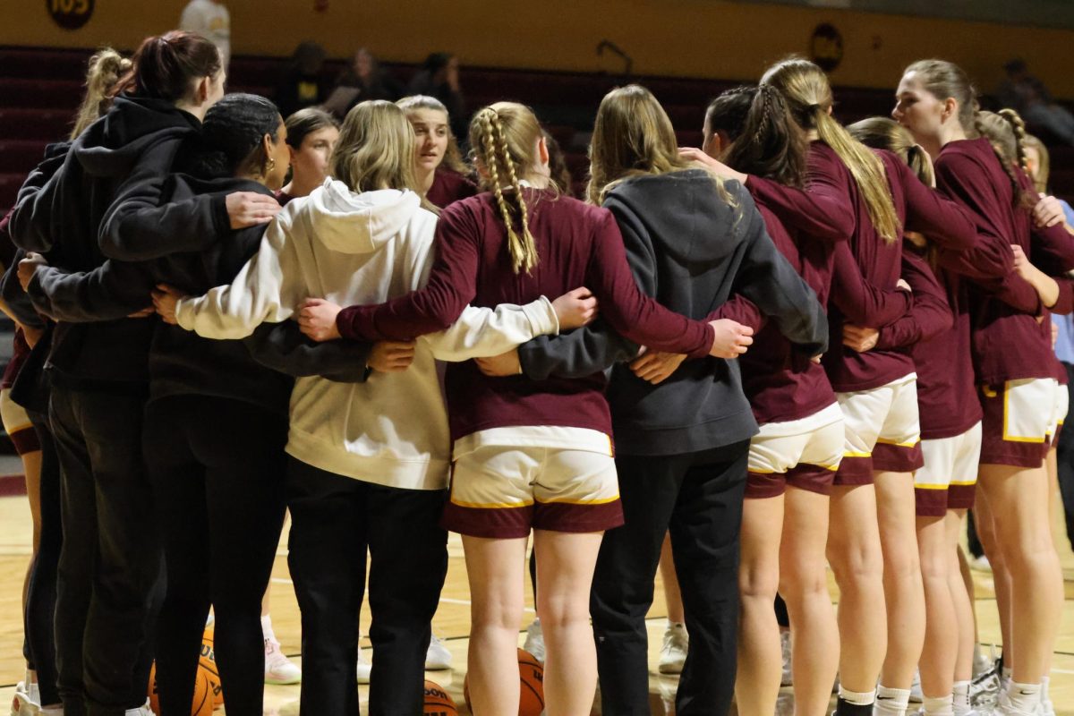 Calvin women's basketball huddles before a game. Photo courtesy of calvin.edu. 